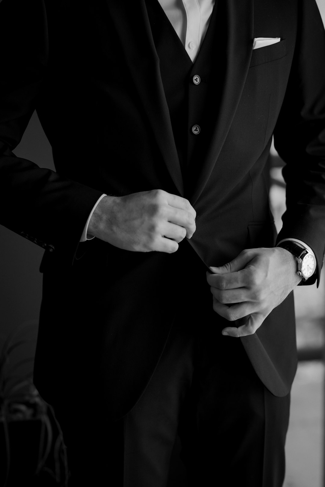 Groom adjusting his tailored formal suit, groom suits Dubai