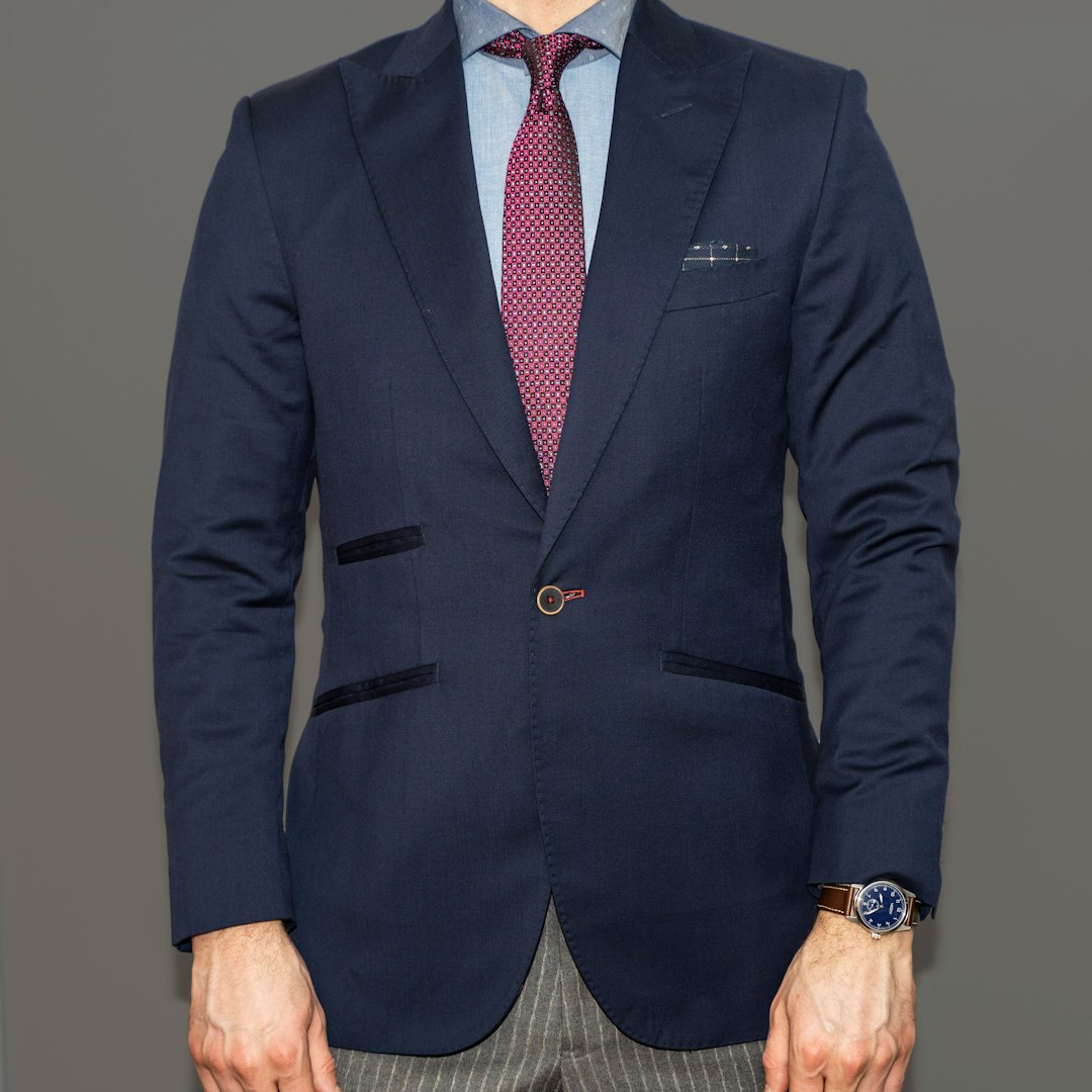 Client in a custom blue blazer and pinstripe trousers, luxury tailor Dubai